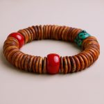 Yak Bone Wrist Mala with Resin Amber, handmade in Nepal by skilled artisans, symbolizes resilience and enhances meditation, fostering inner peace and vitality on your spiritual journey.
