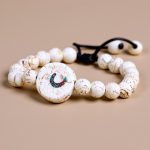 The Conch Shell Wrist Mala, handmade in Nepal by skilled artisans, embodies spiritual significance, purifying negativity and promoting peace through the sacred sound of Om.