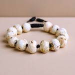 Handmade in Nepal by skilled artisans, this Conch Shell Wrist Mala serves as a spiritual guide, embodying purity and protection while enhancing your meditation practice.