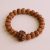 The 5 Faces Rudraksha Seed Wrist Mala, handmade in Nepal by skilled artisans, aids meditation and spiritual connection, embodying devotion and mindfulness on your sacred journey.