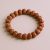 The 5 Faces Simple Rudraksha Seed Wrist Mala, handmade in Nepal by skilled artisans, aids meditation and prayer, fostering peace and spiritual clarity in daily life.