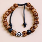 Handmade in Nepal by skilled artisans, this Dzi and Rudraksha seed wrist mala with Onyx stone serves as a sacred companion for meditation and spiritual growth.