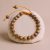 Handmade in Nepal by skilled artisans, this Antique Lotus Seed Wrist Mala embodies purity and spiritual awakening, guiding your journey toward enlightenment and inner strength.