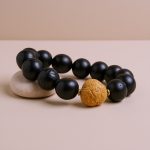 Handmade in Nepal by skilled artisans, this Antique Phoenix Eye Bodhi Seed Wrist Mala symbolizes enlightenment and protection, guiding your spiritual journey with each mindful prayer.