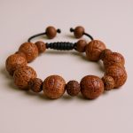 Handmade in Nepal by skilled artisans, this wrist mala features Bodhi and Raktu seeds, serving as a supportive companion for meditation and a reminder of your spiritual journey.