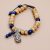 This handmade wrist mala from Nepal combines lotus seeds and Lapis Lazuli, symbolizing purity and wisdom, supporting your meditation and spiritual journey with each mindful breath.