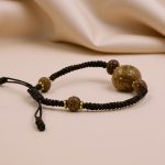 Handmade in Nepal by skilled artisans, this wrist mala features three eye Bodhi seeds and Raktu seeds, symbolizing wisdom, protection, and a deep connection to spiritual practice.