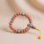 The Inlaid Brass Rudraksha Seed Wrist Mala, handmade in Nepal by skilled artisans, offers protection and emotional balance, embodying the blessings of Lord Shiva for spiritual connection.