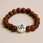 Inlay Indian Bodhi Wrist Mala, handmade in Nepal by skilled artisans, symbolizes the wisdom of the Bodhi Tree, guiding your meditation and enhancing your spiritual journey.