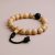 Handmade in Nepal by skilled artisans, this wrist mala combines sacred lotus seed and lava stone, fostering resilience, emotional healing, and a deeper connection to mindfulness and inner peace.