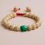 Lotus Seed and Resin Bead Wrist Mala, handmade in Nepal by skilled artisans, symbolizes purity and transformation, fostering mindfulness and resilience in daily practice.