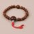 Handmade in Nepal by skilled artisans, this wrist mala features Raktu seeds and a Bodhi seed, embodying spiritual strength and wisdom, perfect for meditation and inner peace.