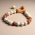 The Rudraksha & Lotus Seed Wrist Mala, handmade in Nepal by skilled artisans, symbolizes spiritual awakening and protection. It is a meaningful companion for meditation and inner peace.