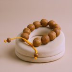Embrace wisdom and protection with the handmade Three Phoenix Eye Bodhi Seed Wrist Mala, crafted by skilled artisans in Nepal, guiding your spiritual journey with each unique seed.