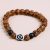 The Tibetan Dzi Rudraksha Seed and Matte Onyx Stone Wrist Mala, handmade in Nepal by skilled artisans, serves as a sacred tool for protection, healing, and spiritual growth.