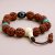 The Tibetan Dzi Rudraksha Seed Wrist Mala, handmade in Nepal by skilled artisans, symbolizes divine protection and inner peace, enhancing your spiritual journey with its sacred materials.