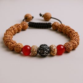 Handmade in Nepal by skilled artisans, this wrist mala features five-faced rudraksha seeds and Tibetan mantra beads, serving as a sacred tool for spiritual connection and inner peace.