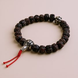 The Dark Rudraksha Seed Wrist Mala, handmade in Nepal by skilled artisans, promotes inner peace and spiritual awakening, connecting you to the protective essence of sacred traditions.