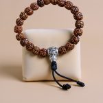 Handmade in Nepal by skilled artisans, this Rudraksha Seed Wrist Mala serves as a sacred companion for mindfulness and meditation, guiding the wearer towards inner peace and spiritual connection.