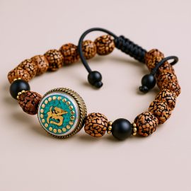 Handmade in Nepal by skilled artisans, this wrist mala features sacred Rudraksha seeds and matte onyx, symbolizing protection and grounding on your spiritual journey.