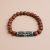 Discover the Wisdom Buddha Eyes Rudraksha Seed Wrist Mala, handmade in Nepal by skilled artisans. This sacred bracelet nurtures meditation, intuition, and inner insight for spiritual seekers.