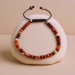 Handmade in Nepal by skilled artisans, this 4 mm Fire Agate Stone Wrist Mala serves as a powerful aid for emotional balance and spiritual practice, fostering harmony and creativity.