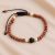Handmade in Nepal by skilled artisans, this 4 mm wrist mala of shining stone and matte onyx symbolizes light and stability, guiding you on your spiritual journey.