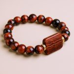 Handmade in Nepal by skilled artisans, this Balancing Tiger Eye Stone Wrist Mala enhances the Solar Plexus Chakra, promoting vitality, discernment, and emotional stability on your spiritual journey.