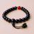 Handmade in Nepal by skilled artisans, this wrist mala features Black Onyx and Carnelian stones, fostering grounding, confidence, and creativity on your spiritual journey.
