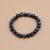 Handmade in Nepal by skilled artisans, this Black Tiger Eye Stone Wrist Mala serves as a protective tool for grounding, promoting balance and clarity in daily life and spiritual practice.