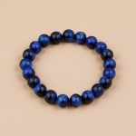 Handmade in Nepal by skilled artisans, this Blue Tiger Eye Stone Wrist Mala embodies calming energy, enhancing intuition and balance while providing protective qualities for the spirit.