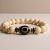 Handmade in Nepal by skilled artisans, this wrist mala combines white jasper and Tibetan Dzi beads, promoting calmness and protection while enhancing your meditation practice.
