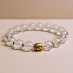 Handmade in Nepal by skilled artisans, this Buddha Crystal Stone Wrist Mala serves as a reminder of clarity and peace, connecting the wearer to the wisdom of the Buddha.