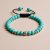 Handcrafted in Nepal, this wrist mala features a Buddha head carved from turquoise, symbolizing protection and spiritual connection, guiding your meditation and journey towards enlightenment.