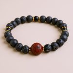 Handmade in Nepal by skilled artisans, this Calming Lava Stone Wrist Mala blends natural lava stone and Bodhi seeds, fostering emotional balance and a deeper connection to the earth.