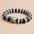 The Buddha Dzi Agate Stone Wrist Mala, handmade in Nepal by skilled artisans, offers protection and healing, embodying the wisdom of the Buddha in every unique bead.