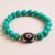 The Dzi & Turquoise Stone Wrist Mala is a handmade treasure from Nepal, embodying Vajrayana Buddhism's spirit and serving as a supportive companion in meditation and healing.