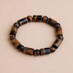 Experience the protective energy of the Flat Tiger Eye Stone Wrist Mala, handmade in Nepal by skilled artisans. This mala enhances meditation and invites positive energies into your life.