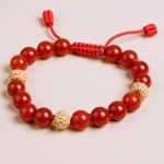 Handmade in Nepal by skilled artisans, this wrist mala features vibrant carnelian stones and sacred rudraksha spacers, promoting vitality, emotional balance, and spiritual awareness in your meditative practice.