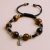 Handmade in Nepal by skilled artisans, this wrist mala features Tiger Eye beads and a Buddha head charm, symbolizing clarity, protection, and the essence of compassion on your spiritual journey.