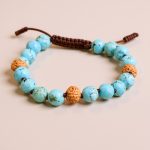 Handmade in Nepal by skilled artisans, this wrist mala features turquoise stones that promote communication and emotional balance, enhancing your meditation and connection to inner peace.