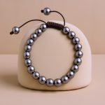 The Hematite Stone Beaded Bracelet Wrist Mala, handmade in Nepal by skilled artisans, aids meditation and promotes inner peace through grounding energy and emotional release.
