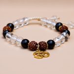 Handmade in Nepal by skilled artisans, this wrist mala combines crystal and matte onyx stones, embodying spiritual connection and mindfulness for your personal growth and meditation practice.