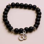 Handmade in Nepal by skilled artisans, this Hindu Om Matte Onyx Stone Wrist Mala supports spiritual growth and mindfulness, enhancing self-control and promoting inner peace through daily reflection.
