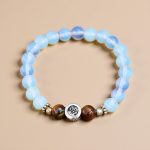 Hindu Om Opal Stone Wrist Mala, handmade in Nepal by skilled artisans, symbolizes hope and purity, enhancing meditation and inner calm on your spiritual journey.