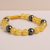 This handmade wrist mala from Nepal features honey calcite and hematite, promoting inner strength, emotional balance, and spiritual growth on your journey of self-discovery.