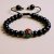 Handmade in Nepal by skilled artisans, this wrist mala features black onyx for grounding and protection, complemented by inlaid brass, aiding your meditation and spiritual journey.