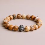 Handmade in Nepal by skilled artisans, this Jasper stone wrist mala features a mantra bead that nurtures compassion and mindfulness, supporting your spiritual journey and connection to the Earth.