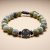Handmade in Nepal by skilled artisans, this wrist mala features labradorite stone for protection and a double dorjee bead symbolizing wisdom and compassion on your spiritual journey.