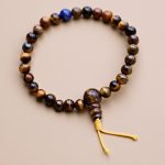 Handmade in Nepal by skilled artisans, this Lapis Lazuli Tiger Eye Stone Wrist Mala supports meditation and emotional balance, fostering courage, wisdom, and spiritual awareness on your journey.